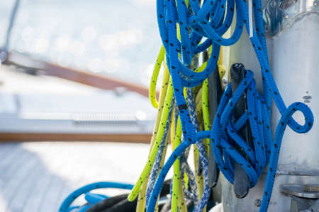 selective focus of coiled marine or nautical rope and cleats on sailboat.の写真素材