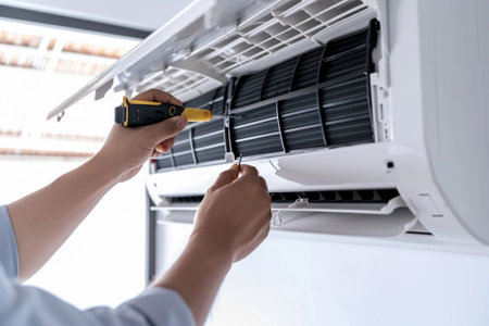 Technician repairing air conditioner indoors, closeup. Professional serviceの素材