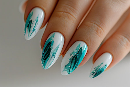 Female hand with light blue nail design. Nail polish manicure.の素材