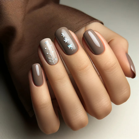 Female hand with brown nail design. Nail polish manicure.の素材