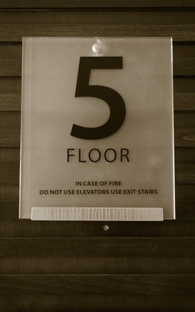The fifth sign is made of glass mounted on a wooden vintage.の写真素材