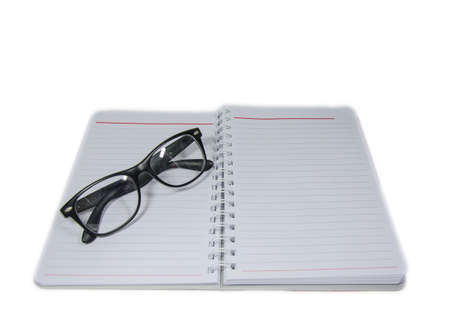 Blank open book on white background with clipping path Glasses placed on top.の写真素材