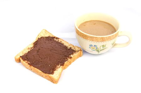 Slice of bread with chocolate cream and coffee mugの写真素材