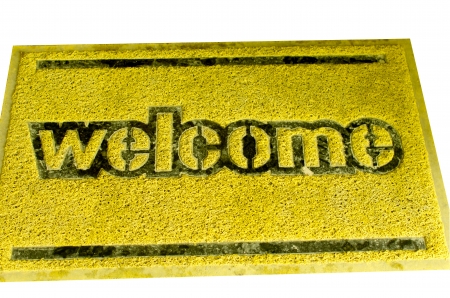 Doormat yellow on a white background. The word welcome.の写真素材
