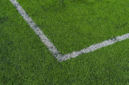 Football-Soccer green grass field, detail of the corner