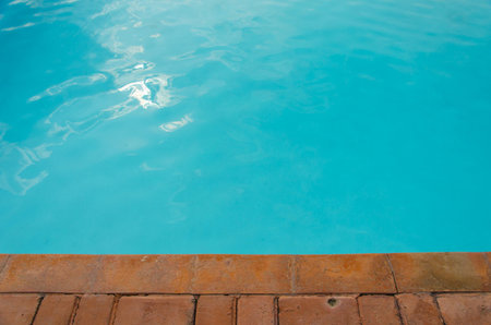 Pure and clear blue water in a swimming pool, summer background