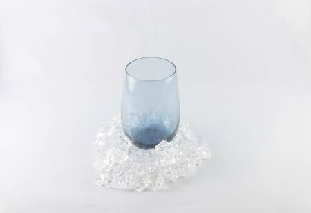 Glass with ice on a white background.の写真素材