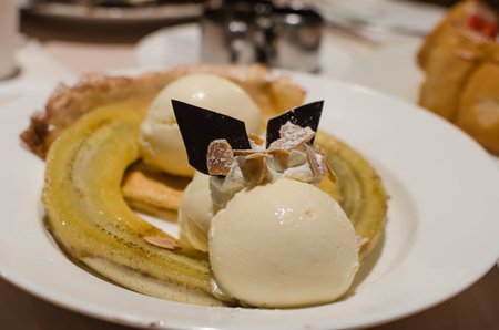 Bananas and vanilla ice cream on a plate.
