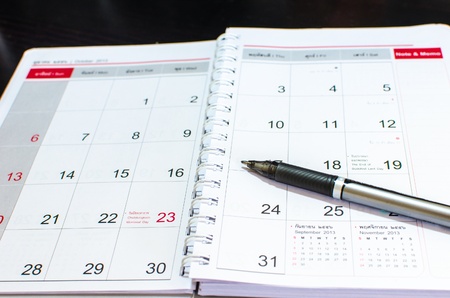 Blank notebook pen placed on a desk の写真素材
