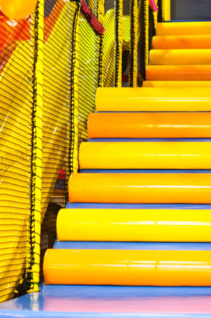 A set of stairs on a playscape at a playground.