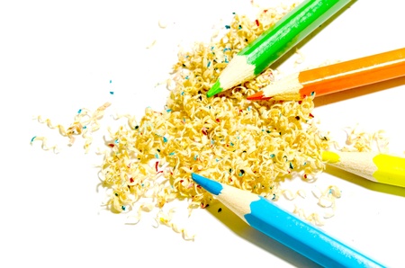 Sawdust colored pencils on white background.の写真素材