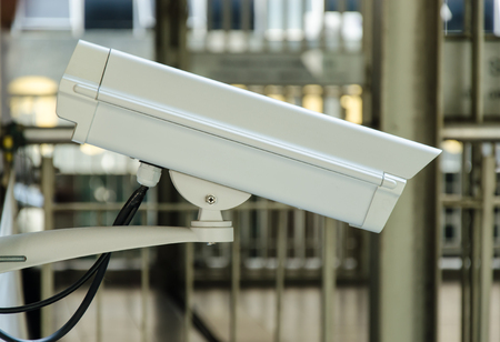 Security cameras attached to the iron railing of the bridge.の写真素材