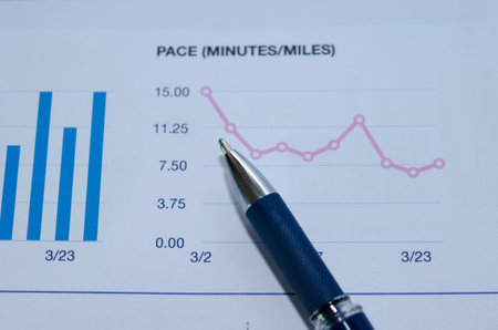 Pen and graphs at a desk.