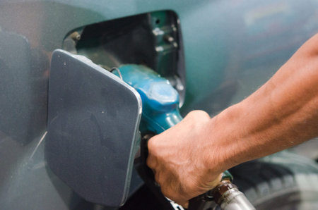 Hand of a man refueling a carの写真素材