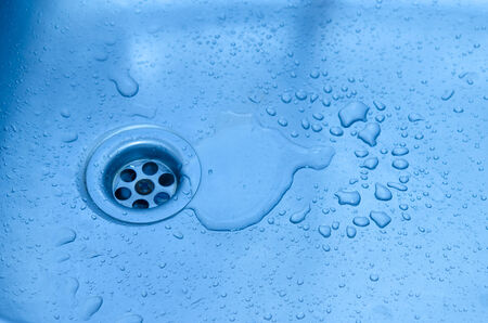 Close-up of kitchen sink with water drops.の写真素材