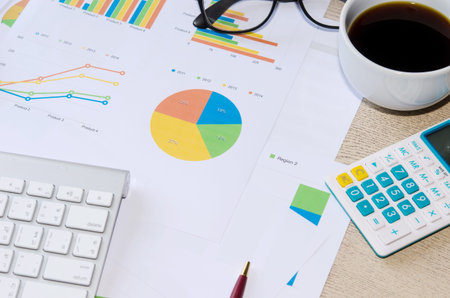 Financial papers, computer and office supplies closeup