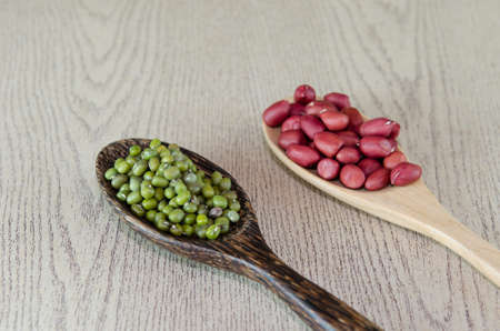 Peanut and Green mung beans on spoon isolated on the white.の写真素材