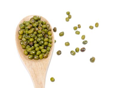 Green beans and wooden spoon isolated on the whiteの写真素材