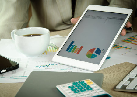 Business people analyzing financial charts and documents