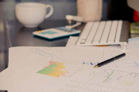 business documents with charts growth, keyboard and pen. workplace businessman