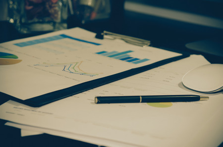 business documents with charts growth and pen.の写真素材