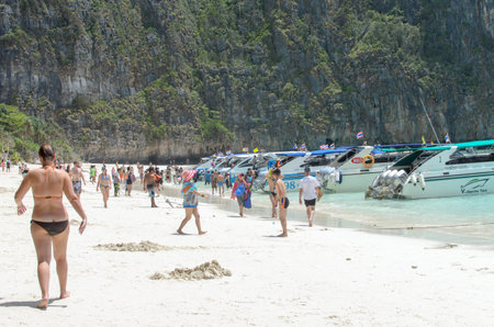 KOH PHI PHI, THAILAND - AUGUST 10: Motor boats on turquoise water of Maya Bay lagoon on Aug 10, 2014 in Koh Phi Phi island, Thailand.のeditorial素材