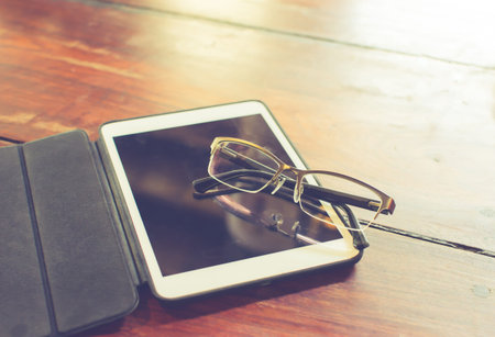 digital tablet on wooden table. vintage lookの写真素材