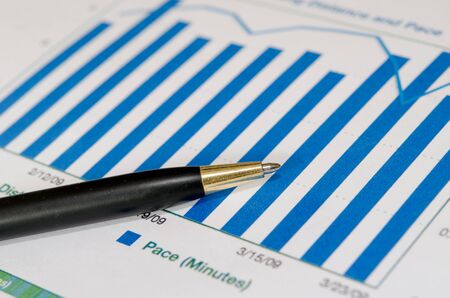 Financial graphs analysis and pen.の写真素材