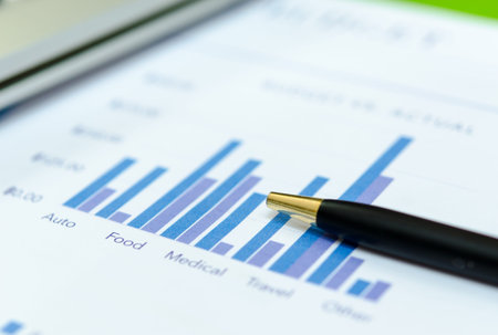 Financial graphs analysis and pen.