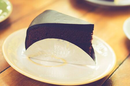 Chocolate cake  on the table.film style color effectの写真素材