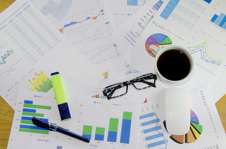 business documents over papers with numbers and charts. View from aboveの写真素材