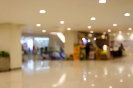 People shopping in department store. Defocused blur background.の写真素材
