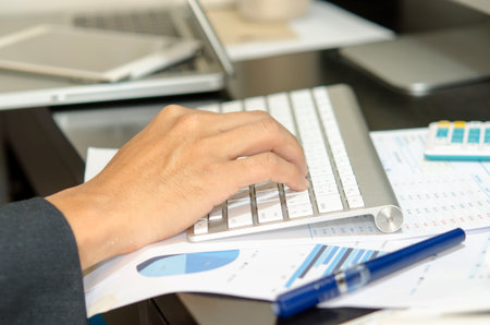 male hands typing on computer keyboard.