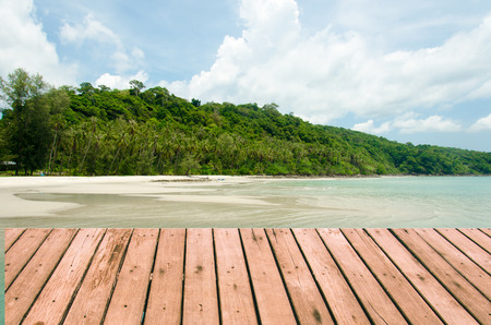palm tree on a background of tropical turquoise sea.Wood planks floor. Beauty nature background.の写真素材