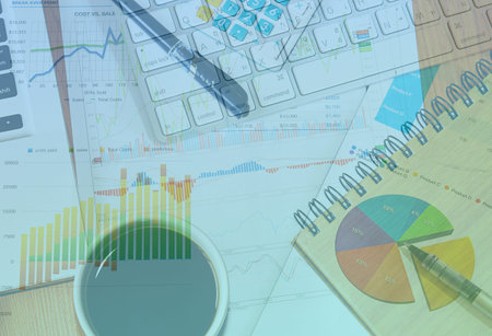 Businessman analyzing investment charts on table.
