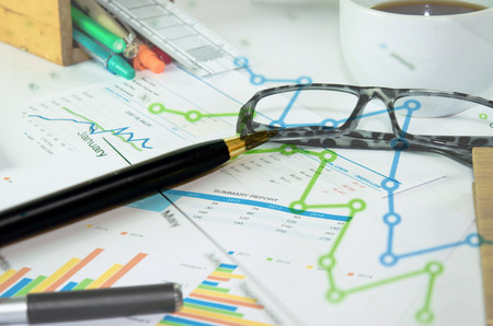 Financial graphs analysis and pen.の写真素材