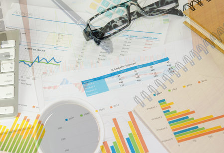 Businessman analyzing investment charts on table. The vintage image.
