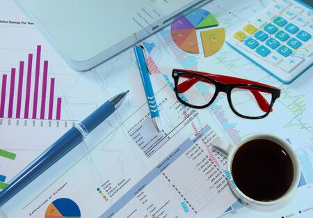 Businessman analyzing investment charts with laptop.の写真素材