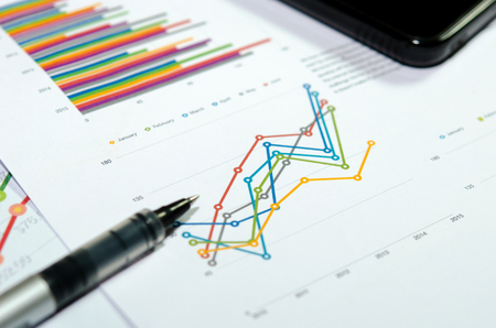 Financial graphs analysis and pen.の写真素材