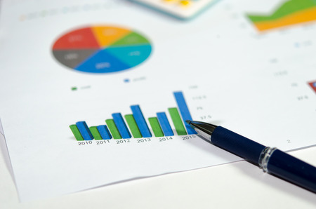 Financial graphs analysis and pen.の写真素材