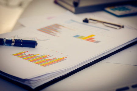 business documents with charts growth, keyboard and pen. workplace businessman
