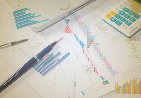 Businessman analyzing investment charts with laptop.の写真素材