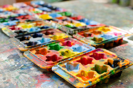 Watercolor tray on a wooden table.