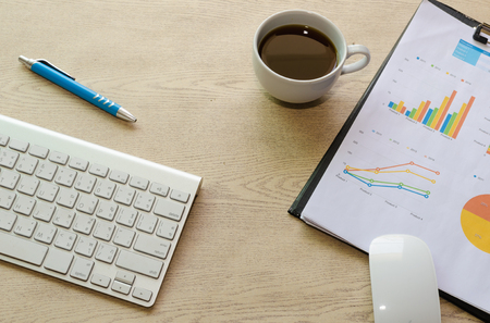 business documents with charts growth,coffee and pen. workplace businessmanの写真素材