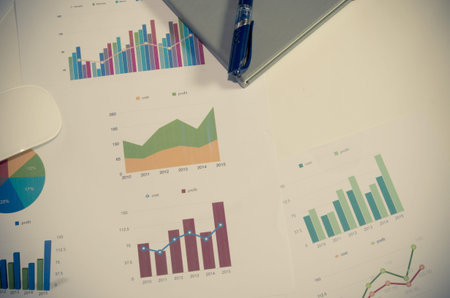 Financial paper charts and graphs on the table