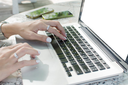 Close up of business woman hand working on laptop computer