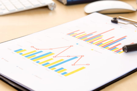 Financial paper charts and graphs on the table