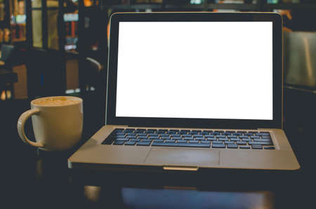 Laptop computer and coffee in the cafe.vintage effect style picturesの写真素材