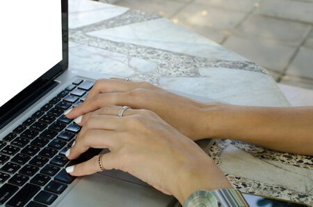 Close up hand working on laptop computer on table.の写真素材