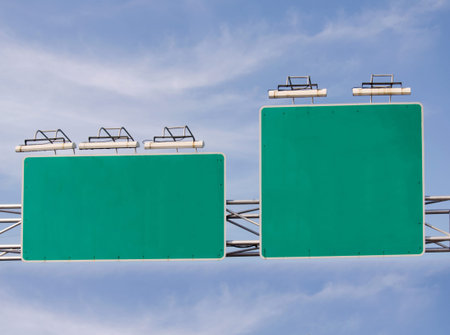 Blank green road sign board on blue sky